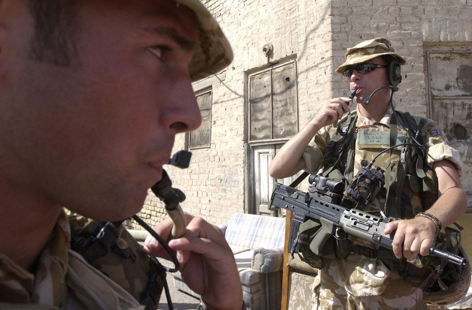 Soldiers of 1st Battalion Cheshire Regiment take on water during a patrol, Basra, Iraq, June, 2004