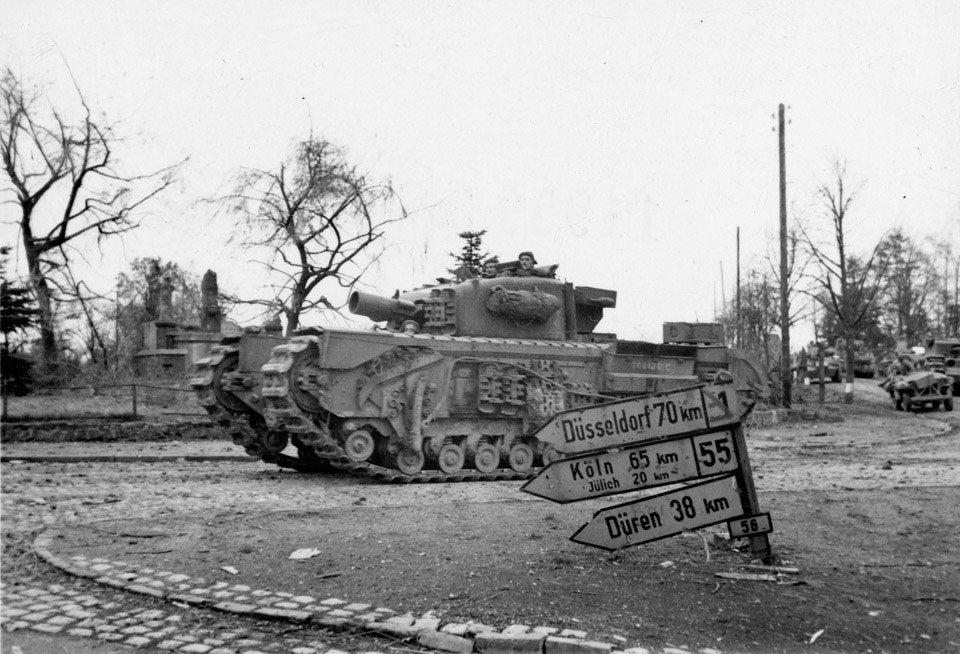 A Churchill AVRE tank enters a German town, 19 November 1944