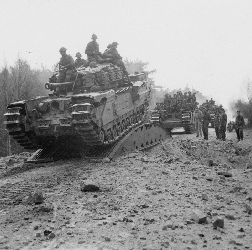 Armoured vehicles crossing a bridged crater, April 1945