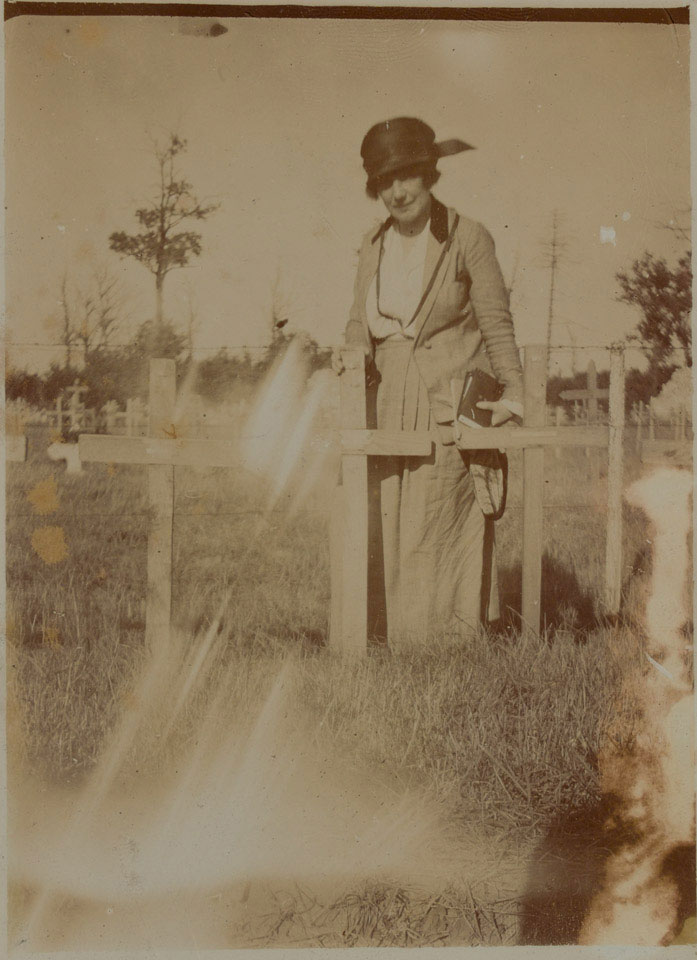 Helen McKie standing by the grave of her brother Douglas McKie, 1919