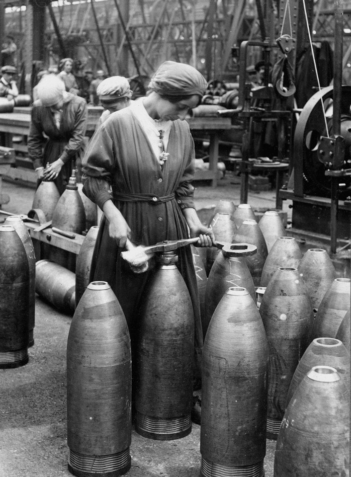 Female munition worker preparing shells in a factory, 1916 (c)