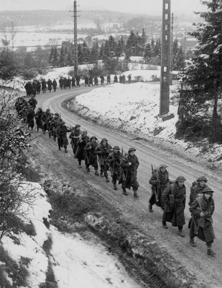 British infantry advancing through the snow, Ardennes, 1945