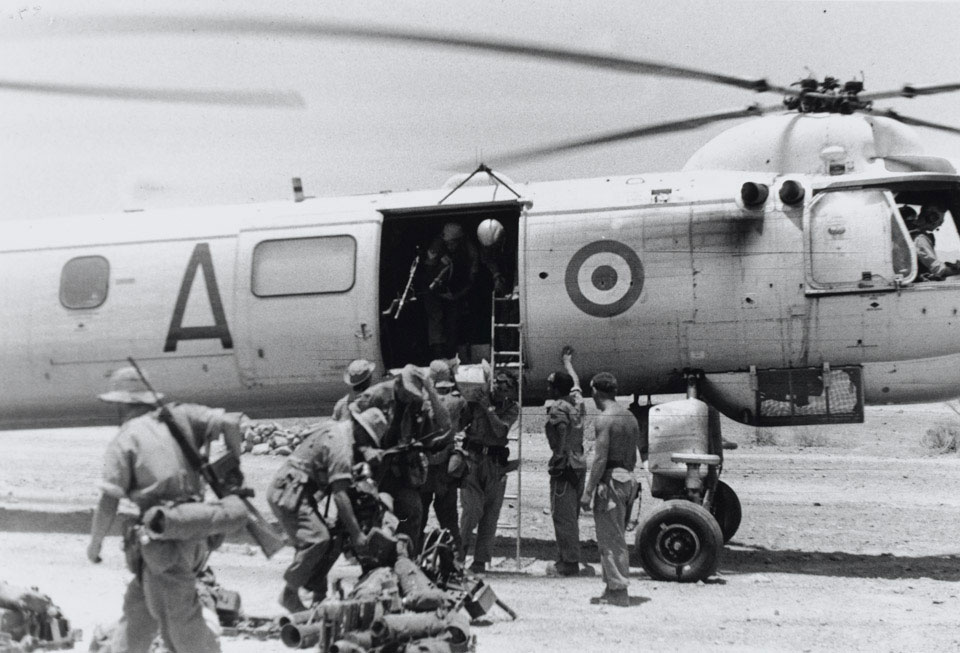 British soldiers embarking on a Bristol Belvedere helicopter in the Radfan, Yemen, 1965 (c)
