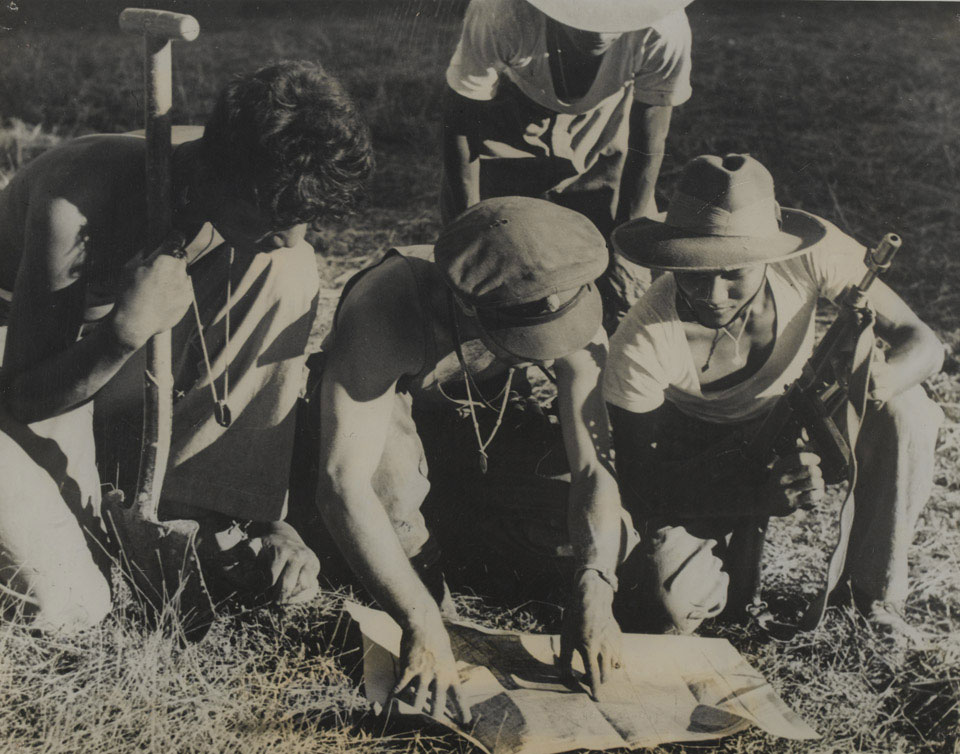 A British Commando officer confers with Burmese soldiers Arakan