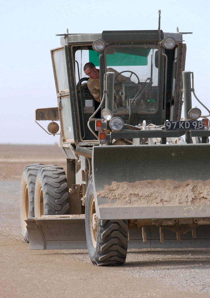 A Royal Engineer Grader works on the Temporary Landing Zone at Camp Bastion, Helmand, Afghanistan, 2006