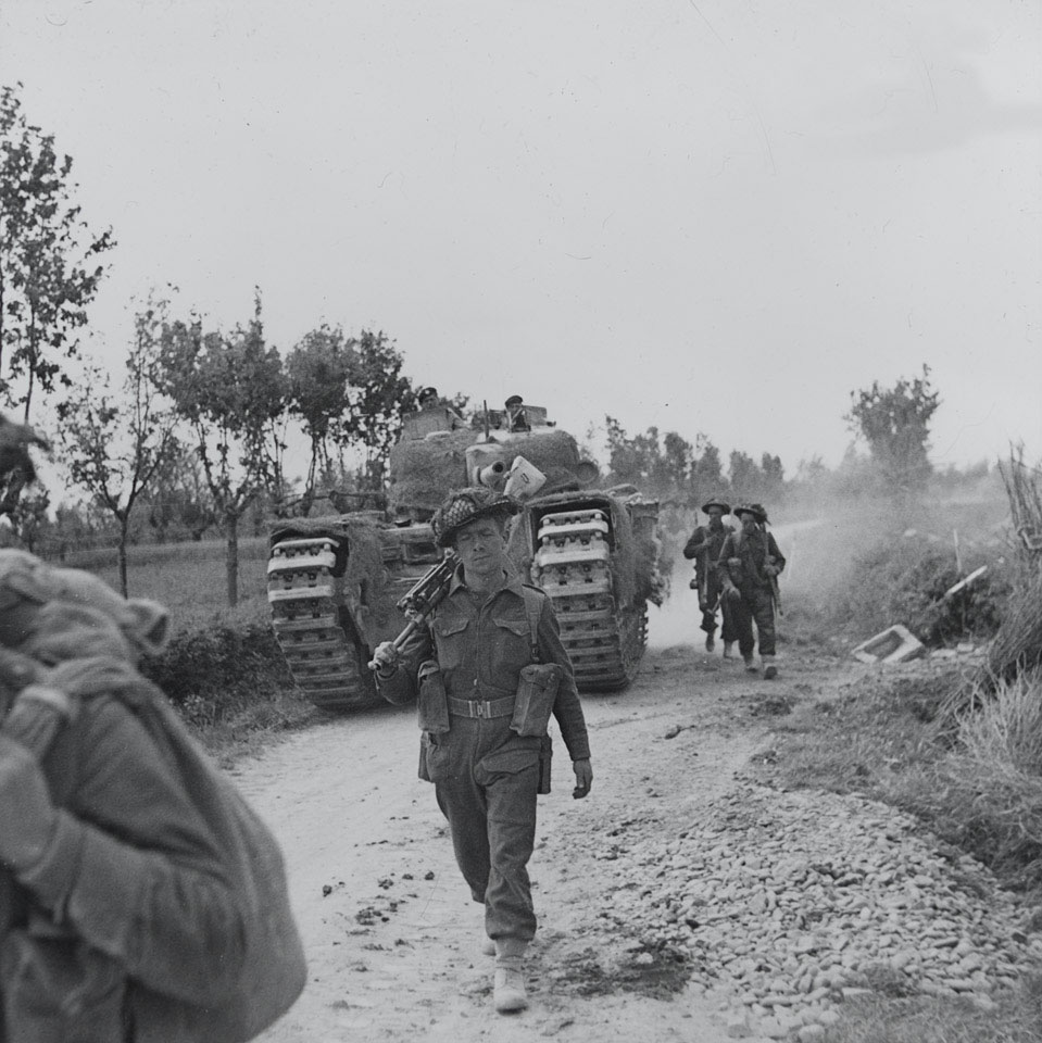 Infantry and supporting tanks advancing along the Argenta road in Italy, April 1945