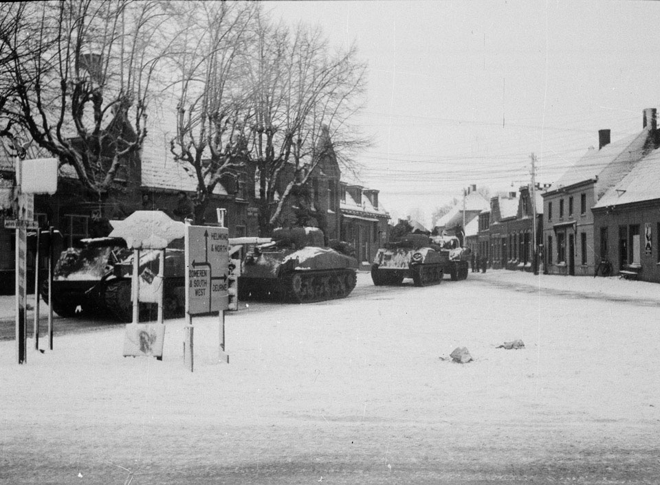 Sherman tanks of 'A' Squadron, 3rd/4th County of London Yeomanry (Sharpshooters) moving through Asten, Netherlands, January 1945