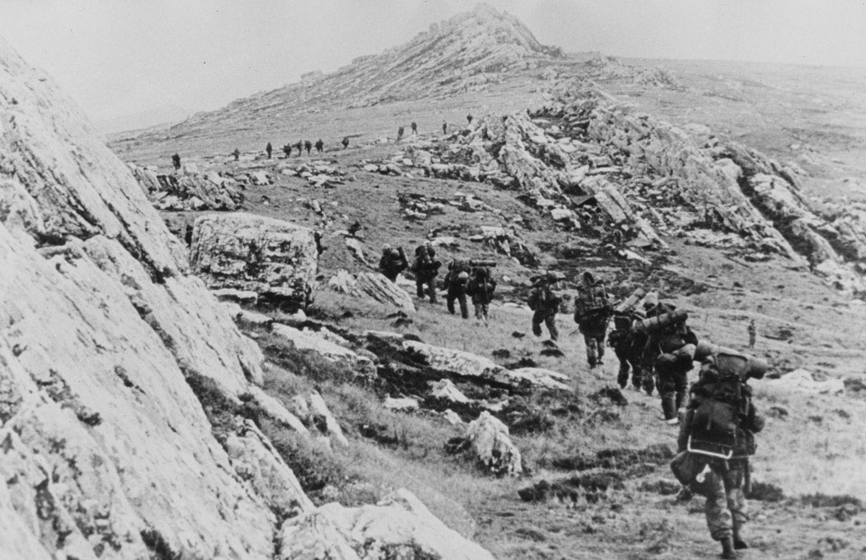British troops march across the rocky Falklands terrain, 1982