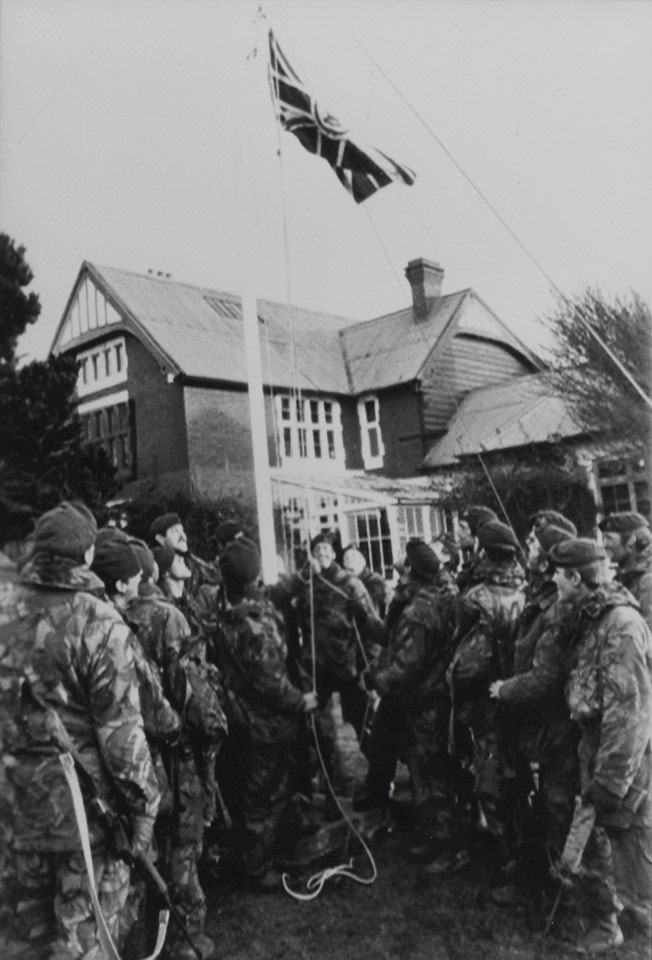 Royal Marine Commandos hoisting the original Union Jack at Government House, Port Stanley, 1982