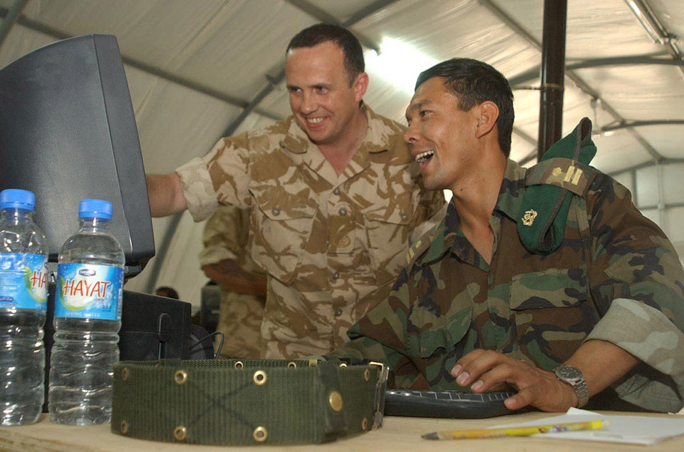 WO2 Ian Adshead, Adjutant General's Corps, mentors an Afghan National Army officer in basic computer skills, 2006
