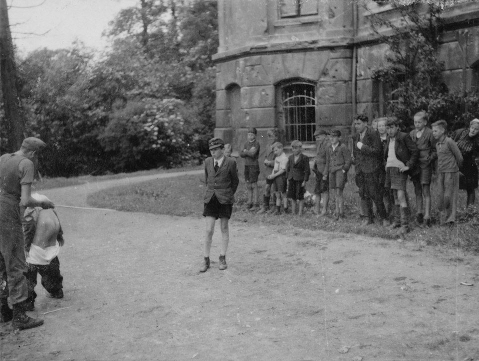 German youths being beaten for stealing from British troops, 1945