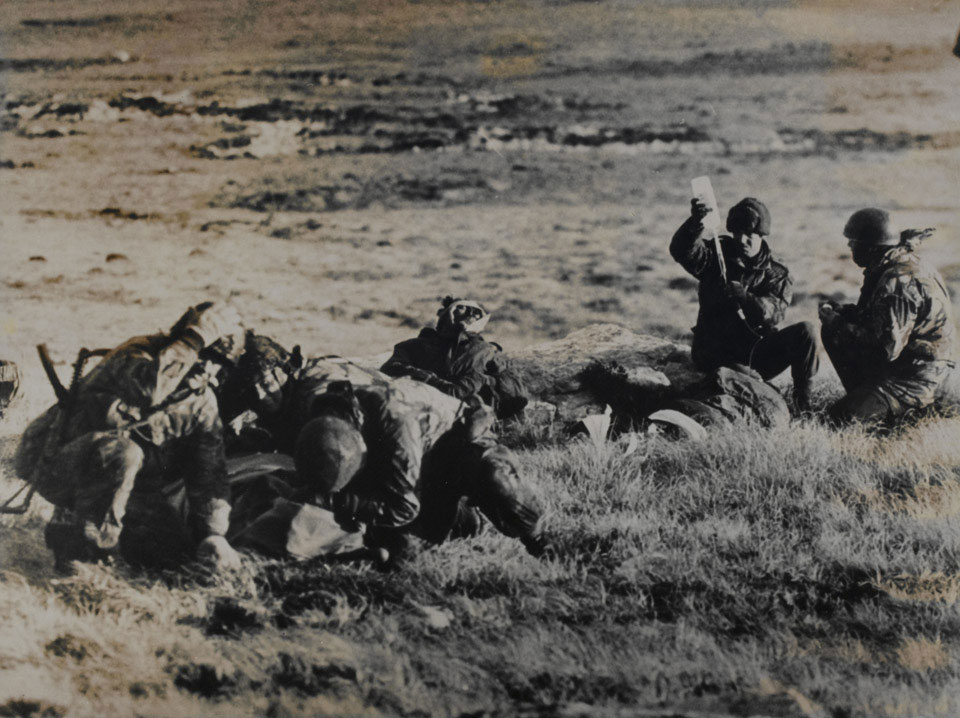 Paramedics attending a wounded Argentine soldier under fire, Mount Longdon, Falkland Islands, 1982