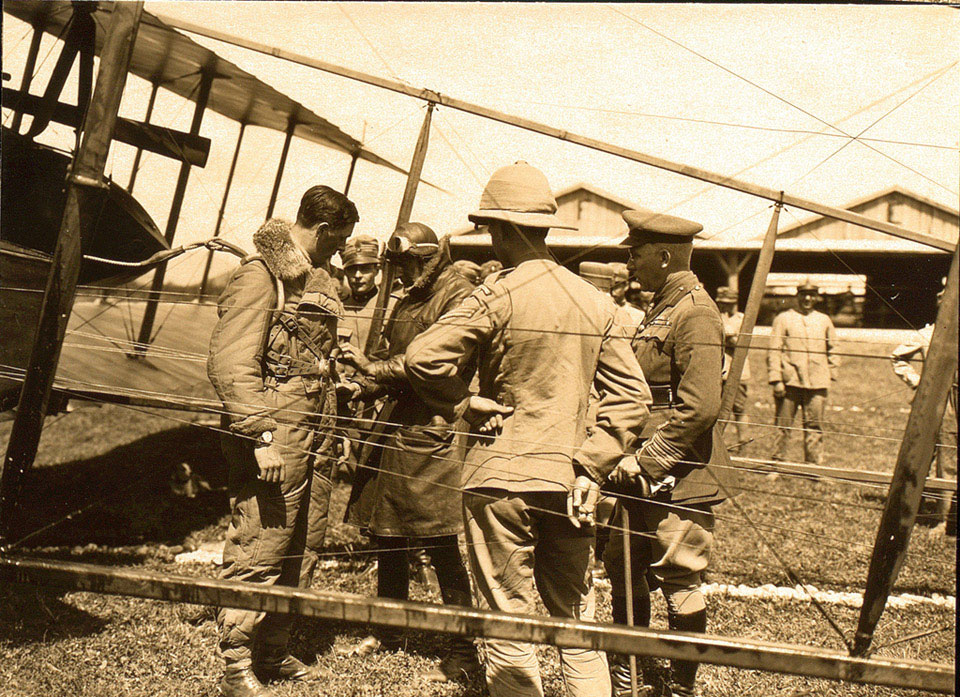 Adjusting the harness of Captain McClure before the drop at San Pelagio aerodrome, 28 June 1918