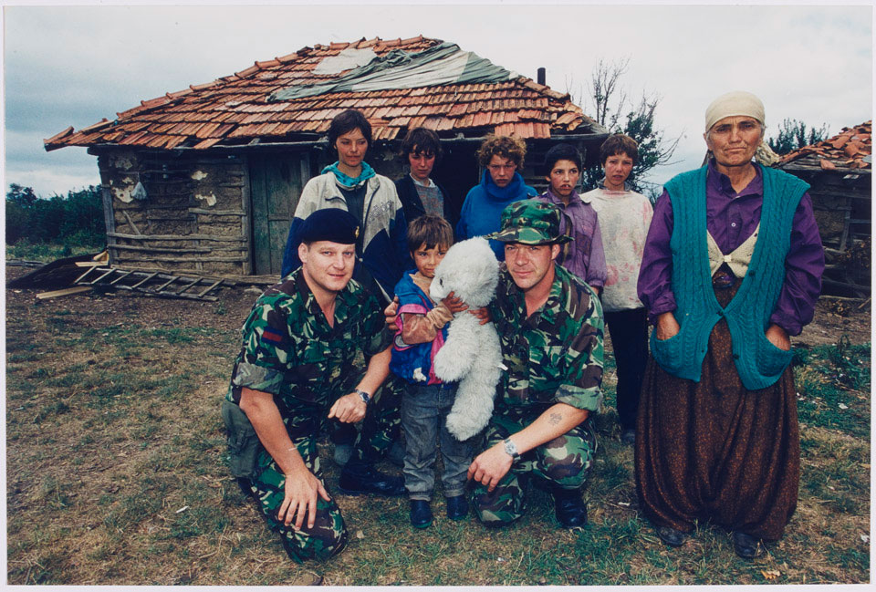 Warrant Officer Garry Pilchowski and Corporal Major Terry Flanagan with members of the Hyseni family, 1999