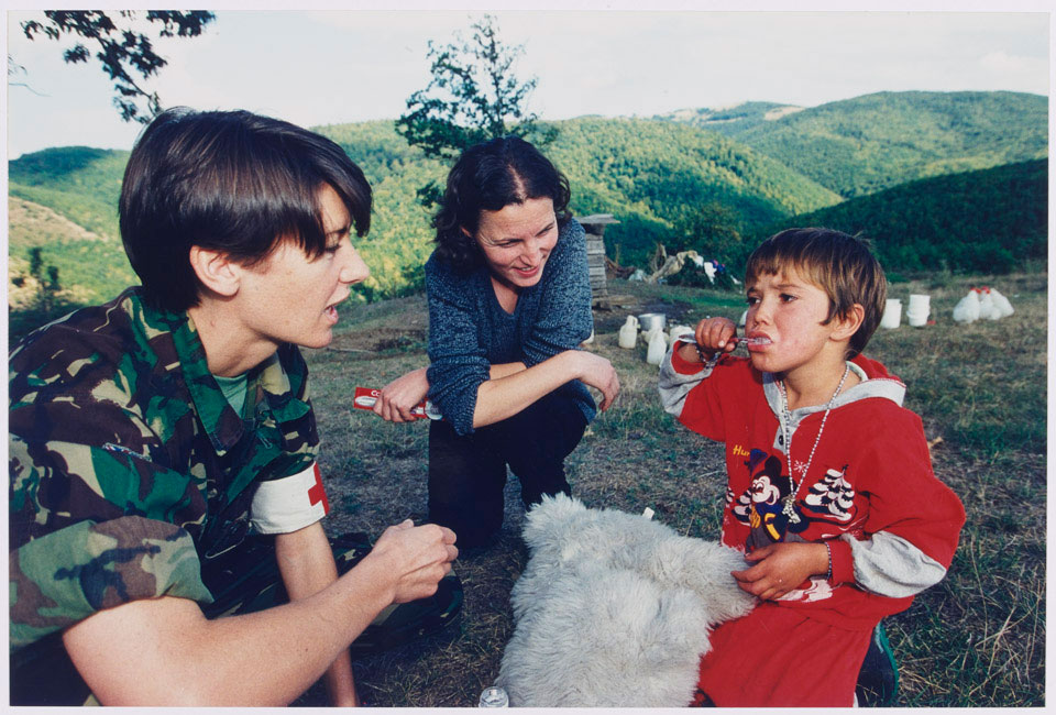 Major Richardson, an Army dentist, with some of the Hyseni children, 1999