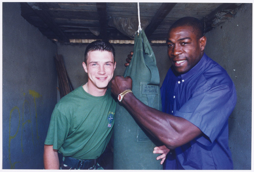 Frank Bruno meets Guardsman Patrick O'Keef, boxing champion of 1st Battalion The Irish Guards, Kosovo, 1999