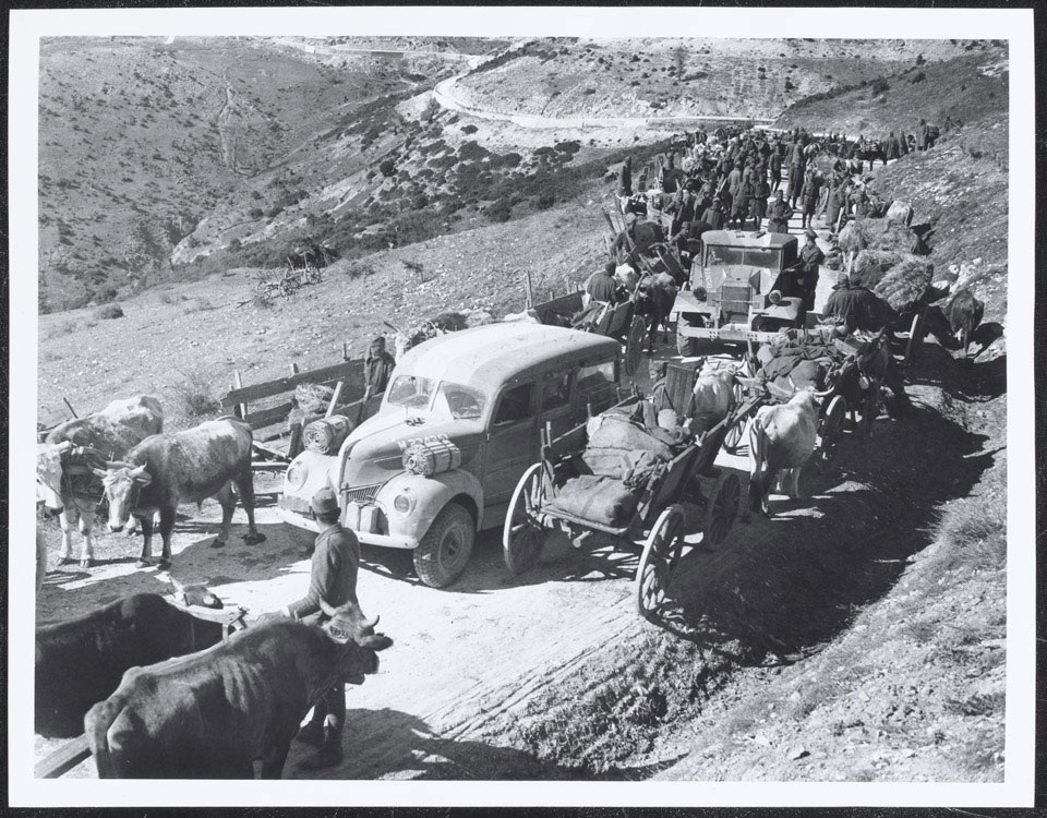 British vehicles pass through a Greek column, 1941