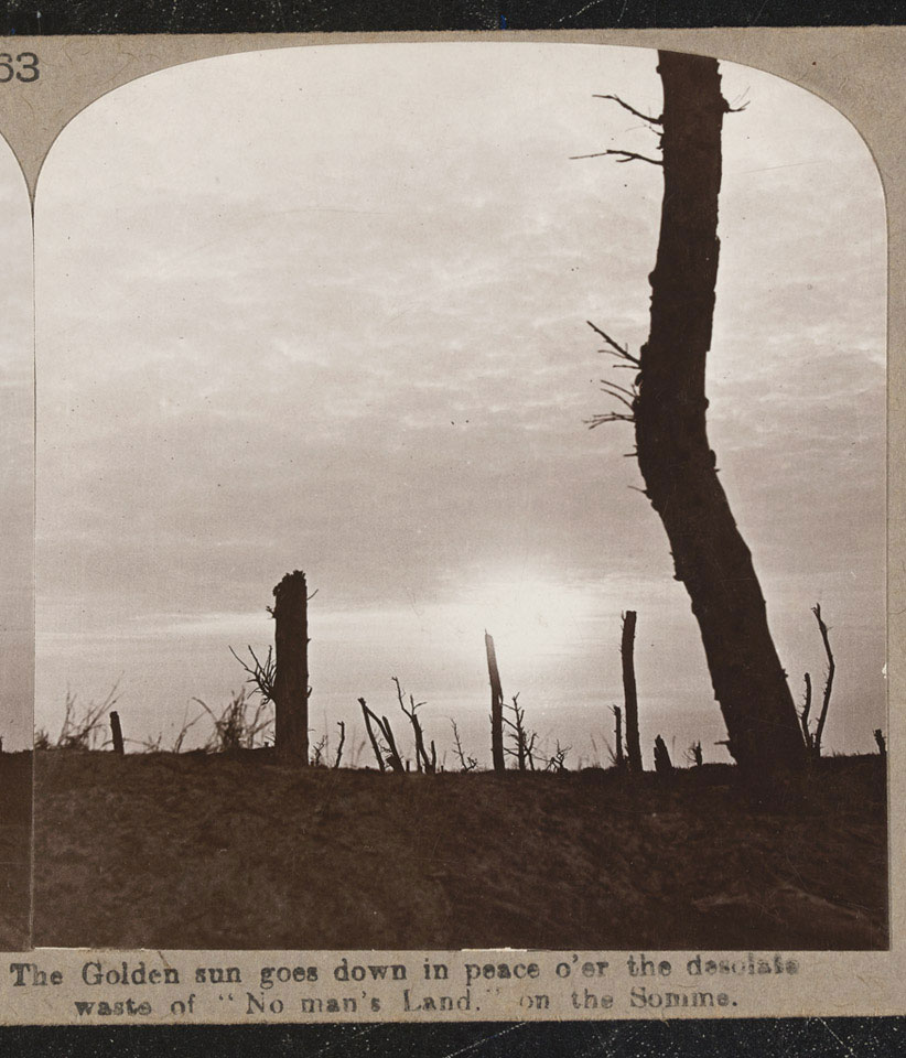'The golden sun goes down in peace over the desolate waste of 'No Man's Land' on the Somme.' Stereoscopic photograph  c. 1916