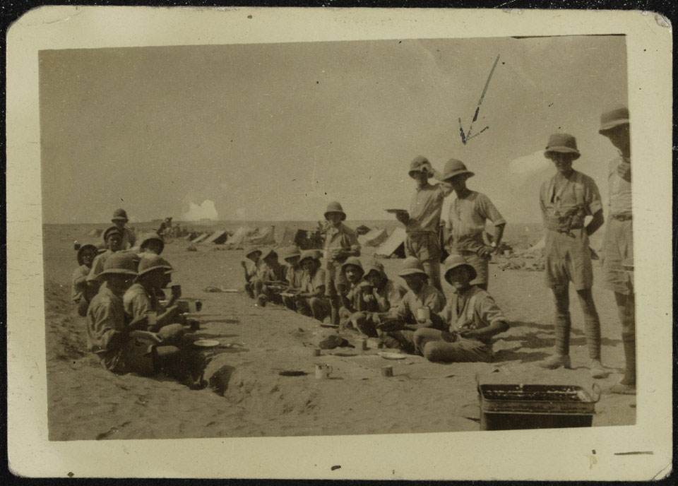 Corporal Joseph Egerton and British soldiers enjoying lunch in the desert near Tel-El-Jemmi, Palestine 1917