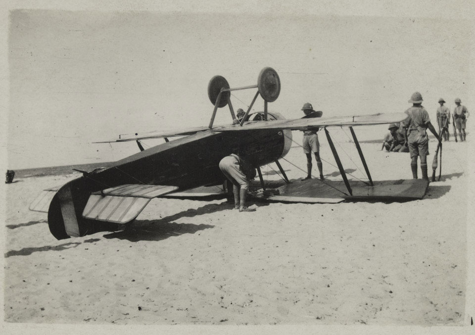British forces inspect an upside down Sopwith Camel, crashed on a beach in Palestine October 1917