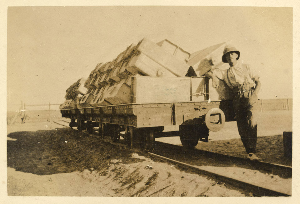 Corporal Joseph Egerton with a rail truck of empty water tanks in Libya, 1916