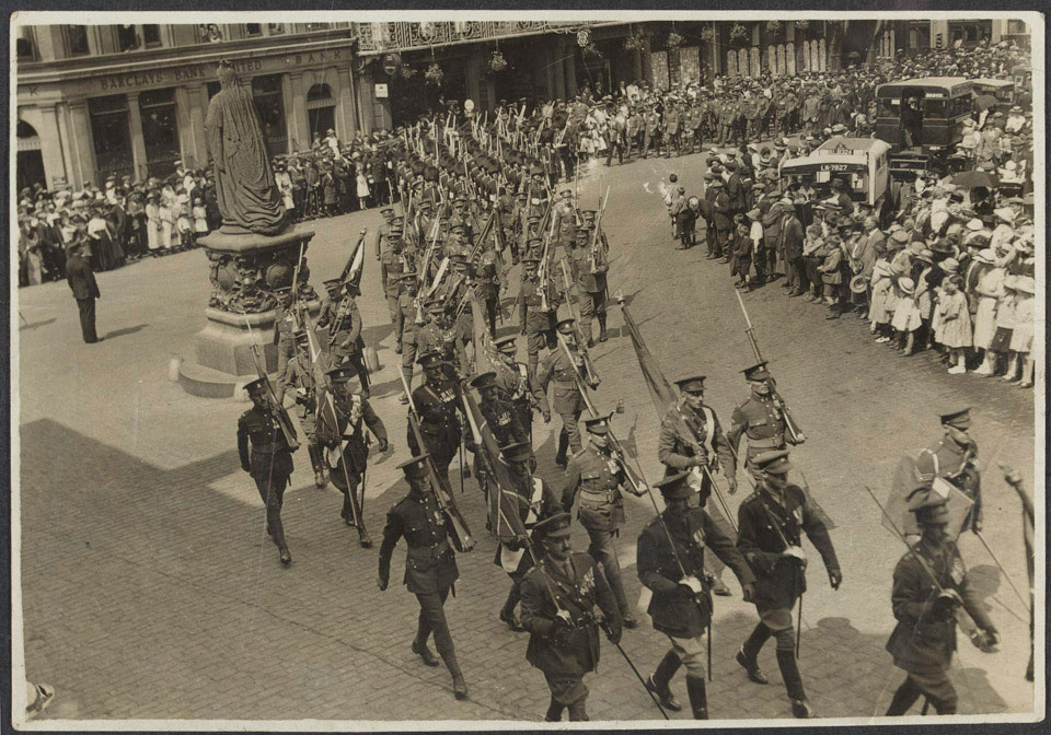 Colour party carrying the colours of the Irish regiments marching past the statue of Queen Victoria, Castle Hill, Windsor, on the occasion of the their disbandment, 12 June 1922