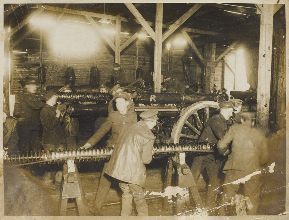 'In a gunrepair shop near the British front line; renewing the springs of a gun recoil', 1916