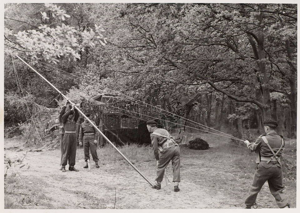 Soldiers of the Royal Corps of Signals erect a radio aerial, 1955 (c)