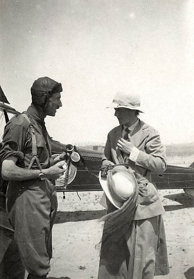 Captain William Leith-Ross talking to a visiting dignitary shortly after landing his aircraft, Mesopotamia, April 1919