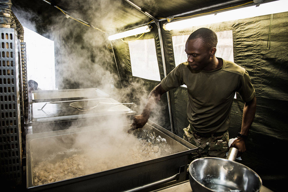 A chef of the Royal Logistic Corps prepares food for the King's Royal Hussars Battle Group, Exercise BLACK EAGLE, Poland, 2014