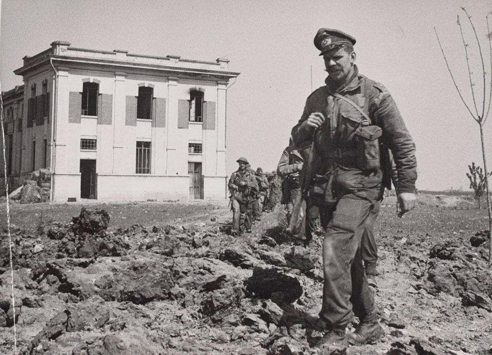 Men of 40 Royal Marine Commando leave a power plant they destroyed at Lake Comacchio, Italy, 11 April 1945