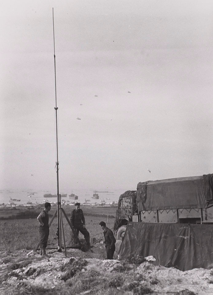 A signals unit erecting a radio mast on one of the Normandy beaches, June 1944