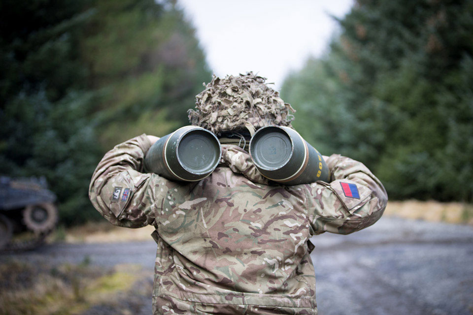 A soldier carrying high explosive ammunition for an AS90 self-propelled gun, Otterburn Training Area, North Yorkshire, 2015
