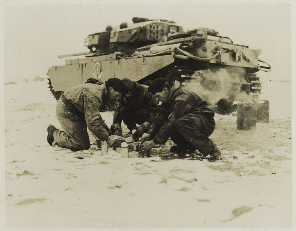 A tank crew from the 8th (King's Royal Irish) Hussars make a meal during their service on the Imjin, 1951
