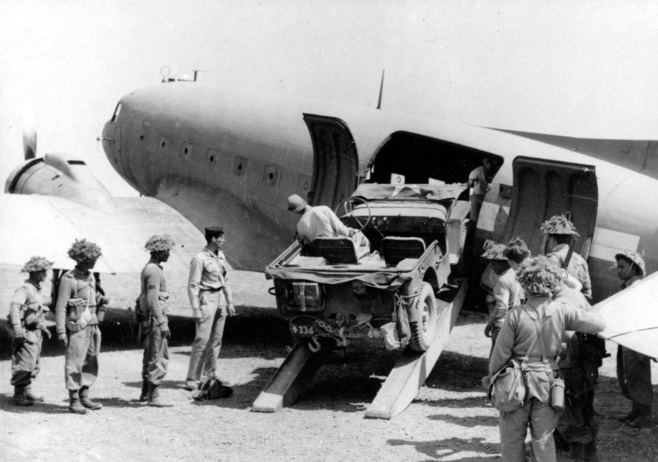 A jeep being loaded into the fuselage of a Dakota transport plane, 1944 (c)