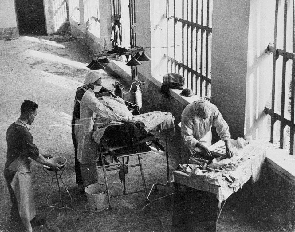 An operation being carried out by a Field Surgery Unit, Royal Army Medical Corps, in an Italian prison still under enemy fire, 1944 (c)