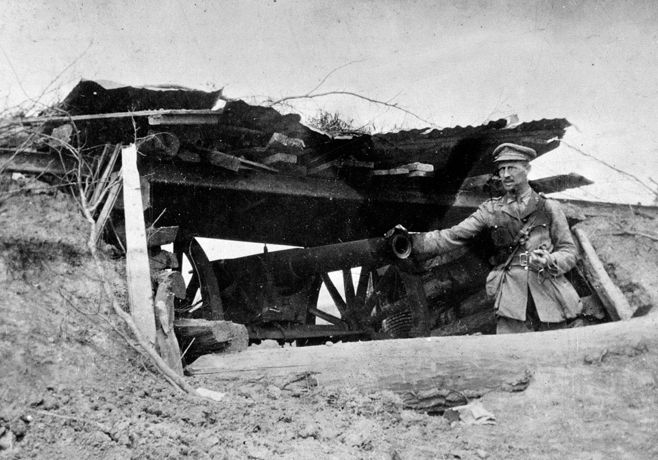 'Lieutenant May, RFA examining a gun captured at Pozieres by 1st Divsion ANZACS, July 1916'