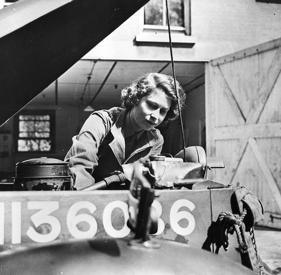 Princess Elizabeth working on a car engine, 1945