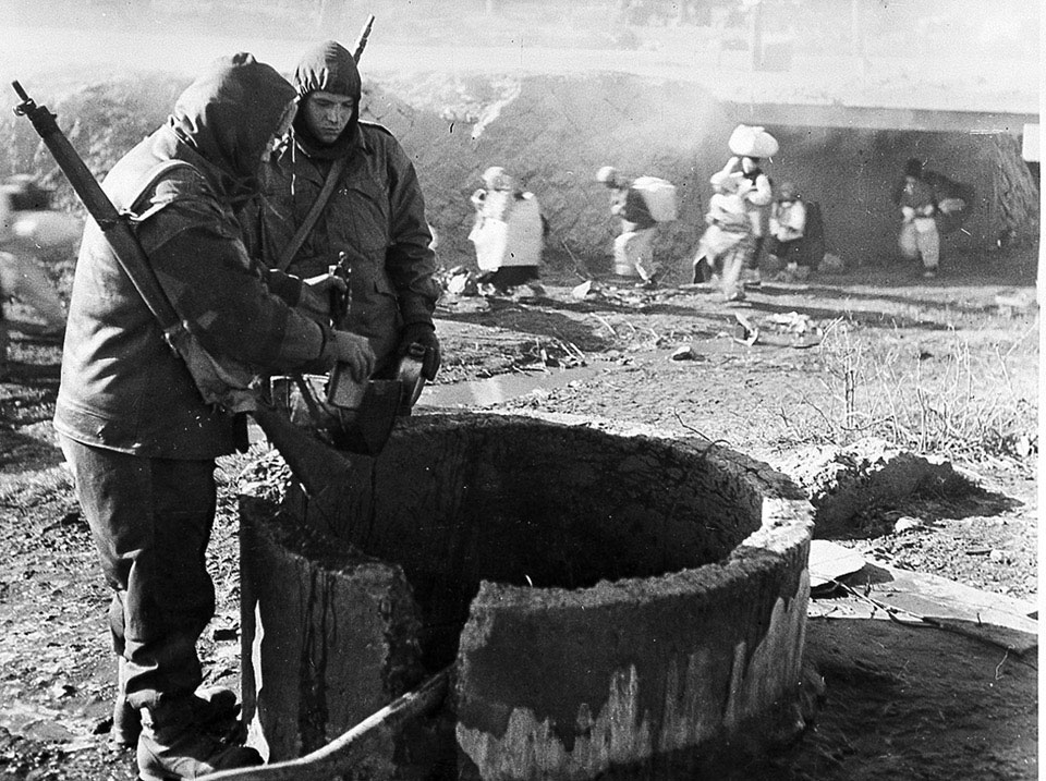 Two soldiers at a well, Korea, 1950 (c)